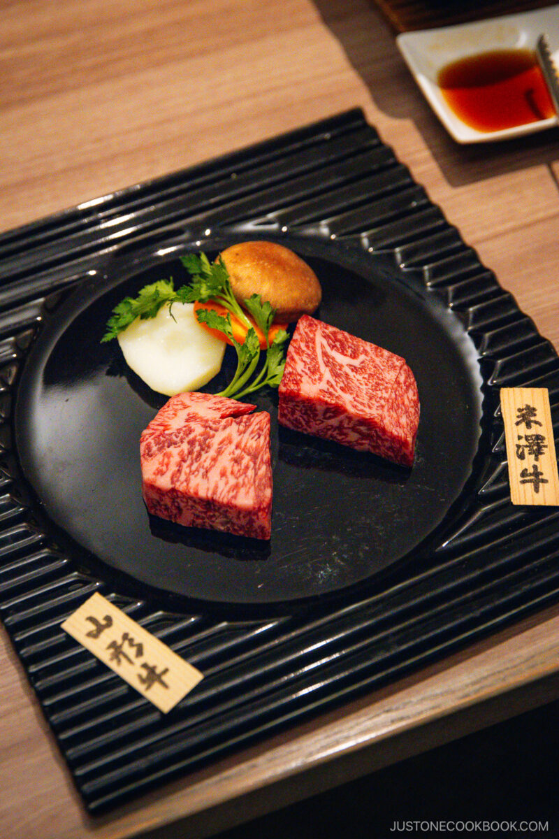 Two different cuts of wagyu beef with vegetables