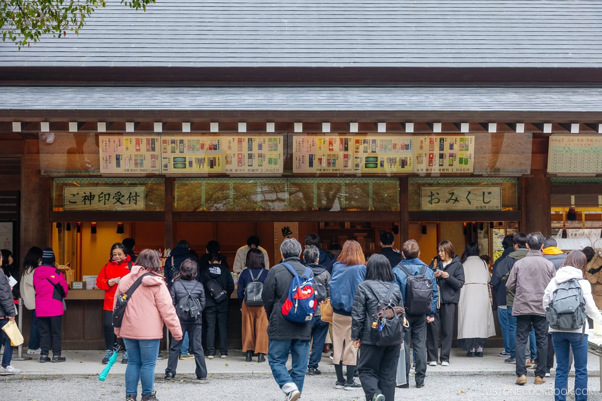 people buying good luck charms from shrine