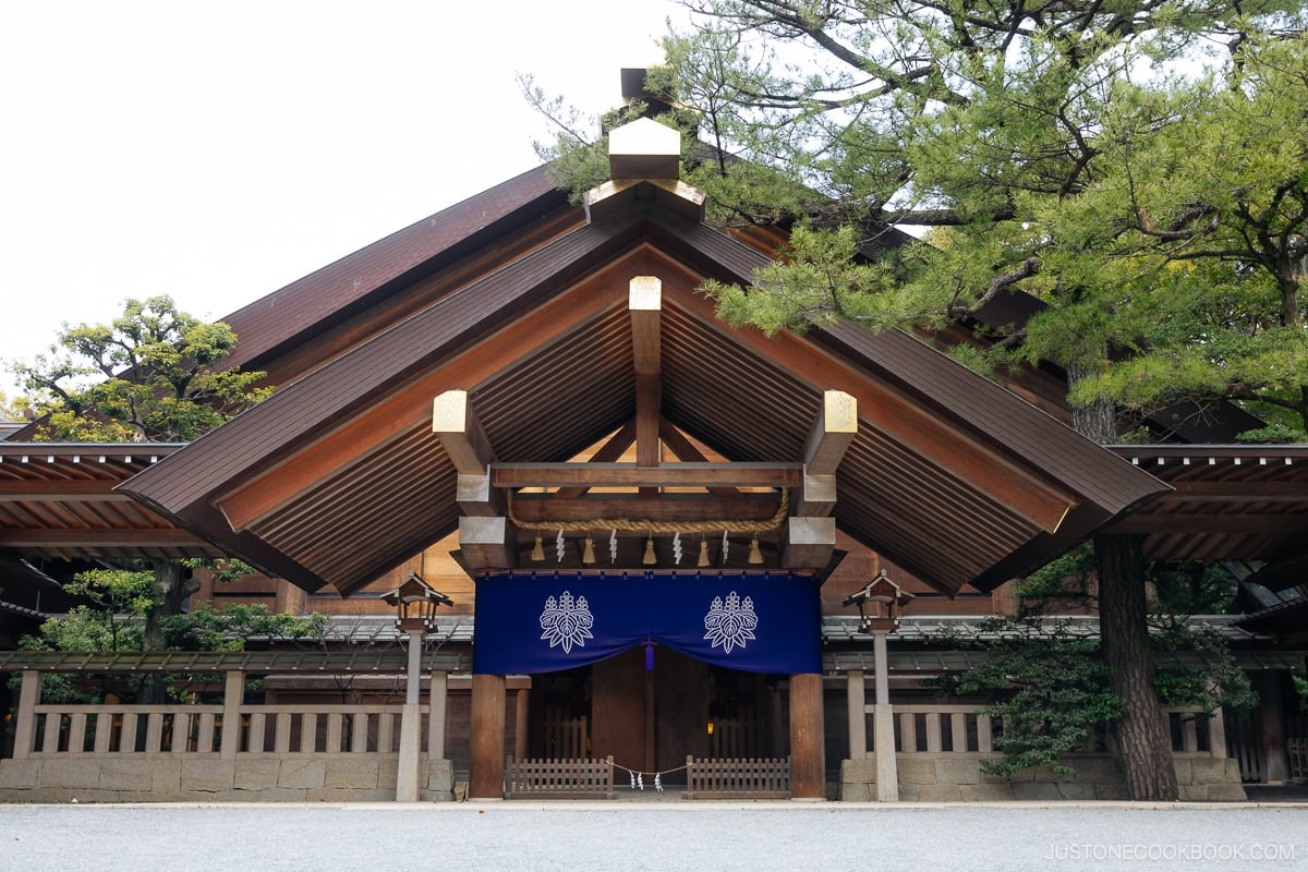 shrine with gold accents and blue clothes hanging in front