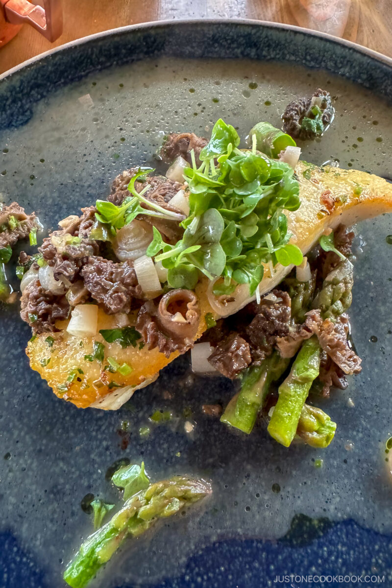 pan fried fish on a dark blue plate