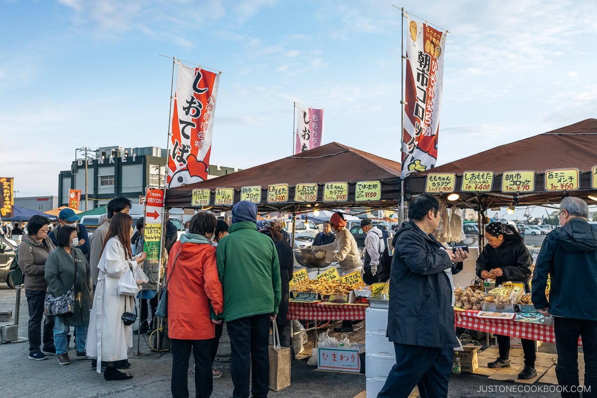 People lining up for deep fried food market stall