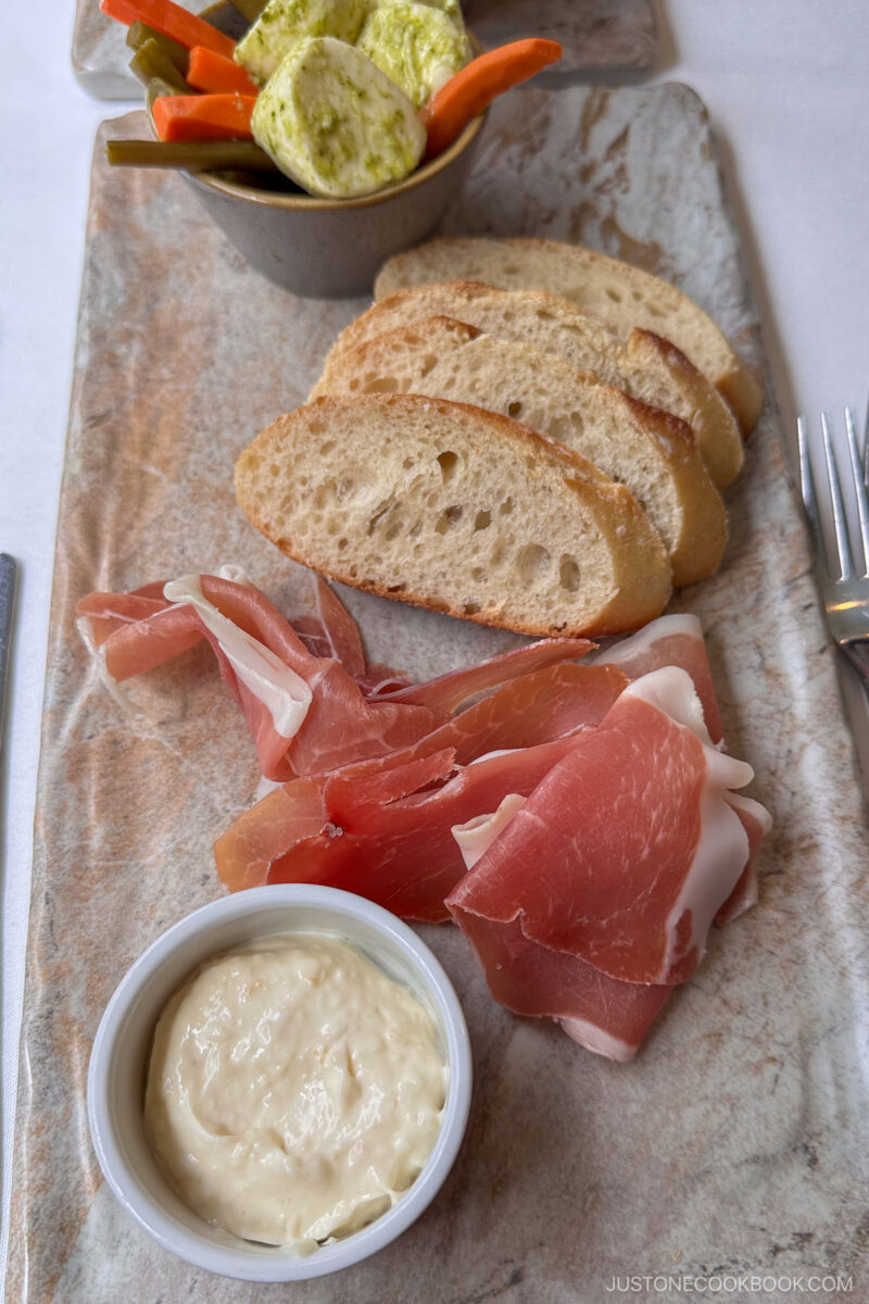 bread and cured meat on a plate