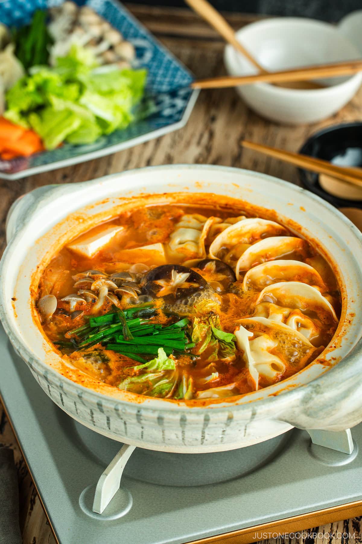 Kimchi Gyoza Nabe served in donabe (Japanese earthenware pot).
