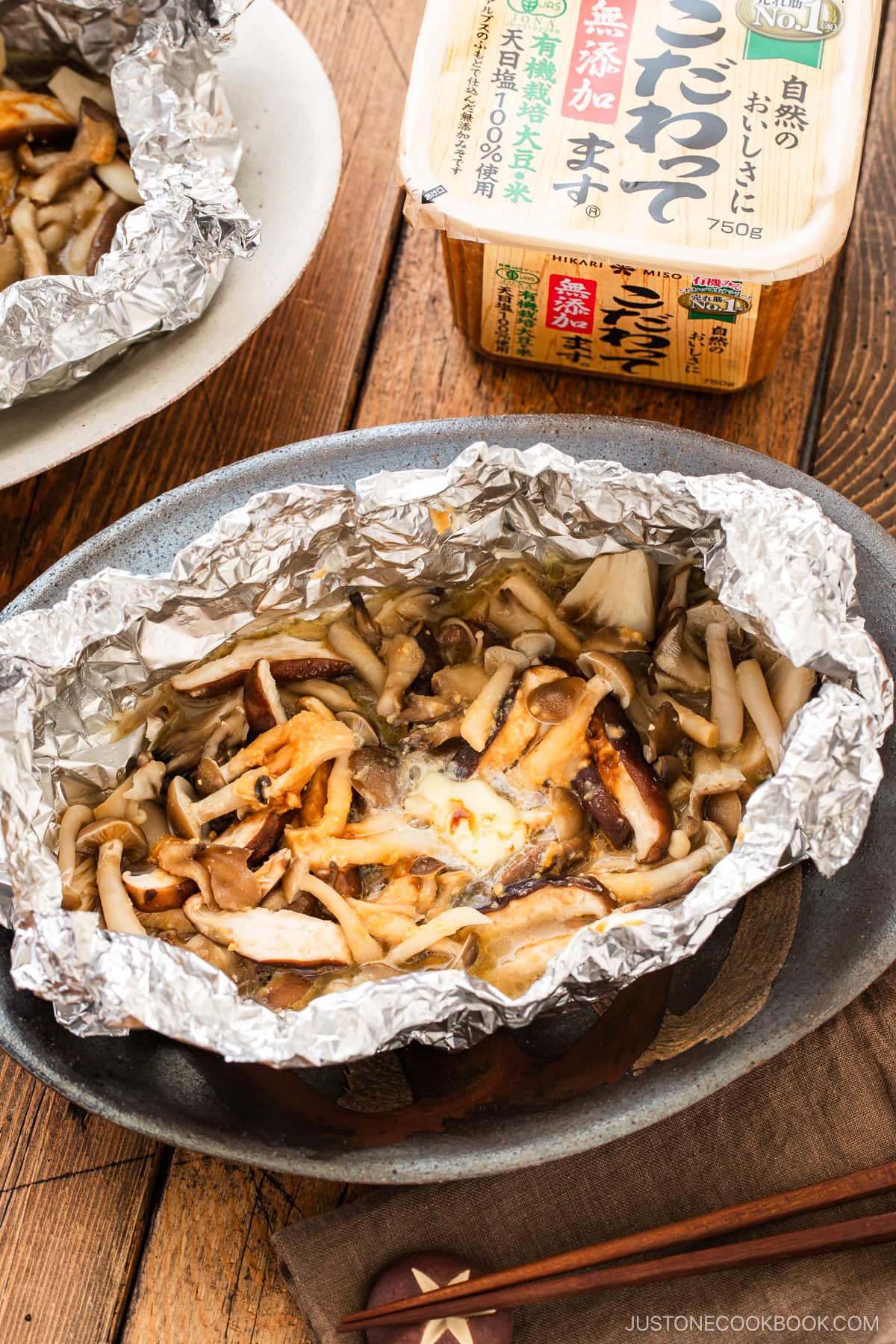 Assortment of mushrooms are wrapped and cooked in foil with miso and butter.
