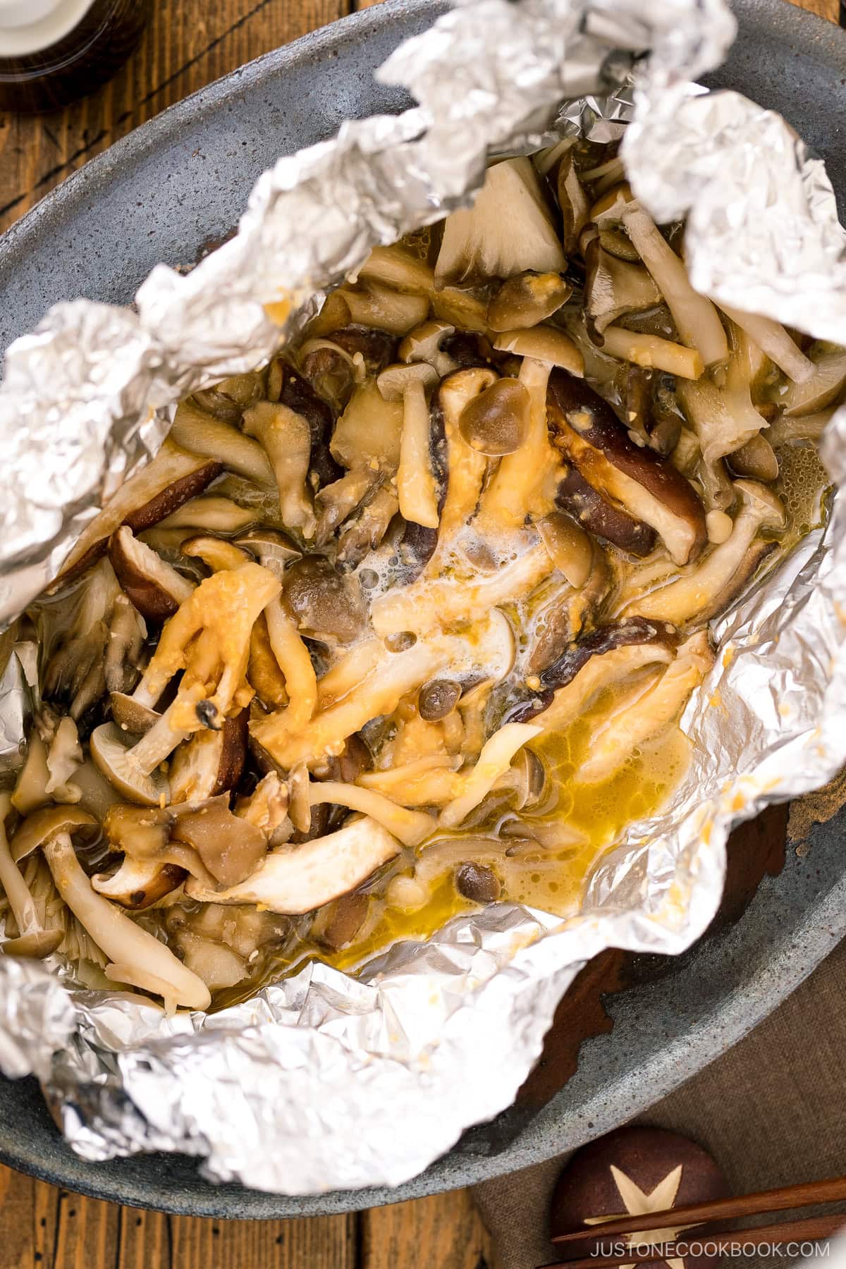 Assortment of mushrooms are wrapped and cooked in foil with miso and butter.