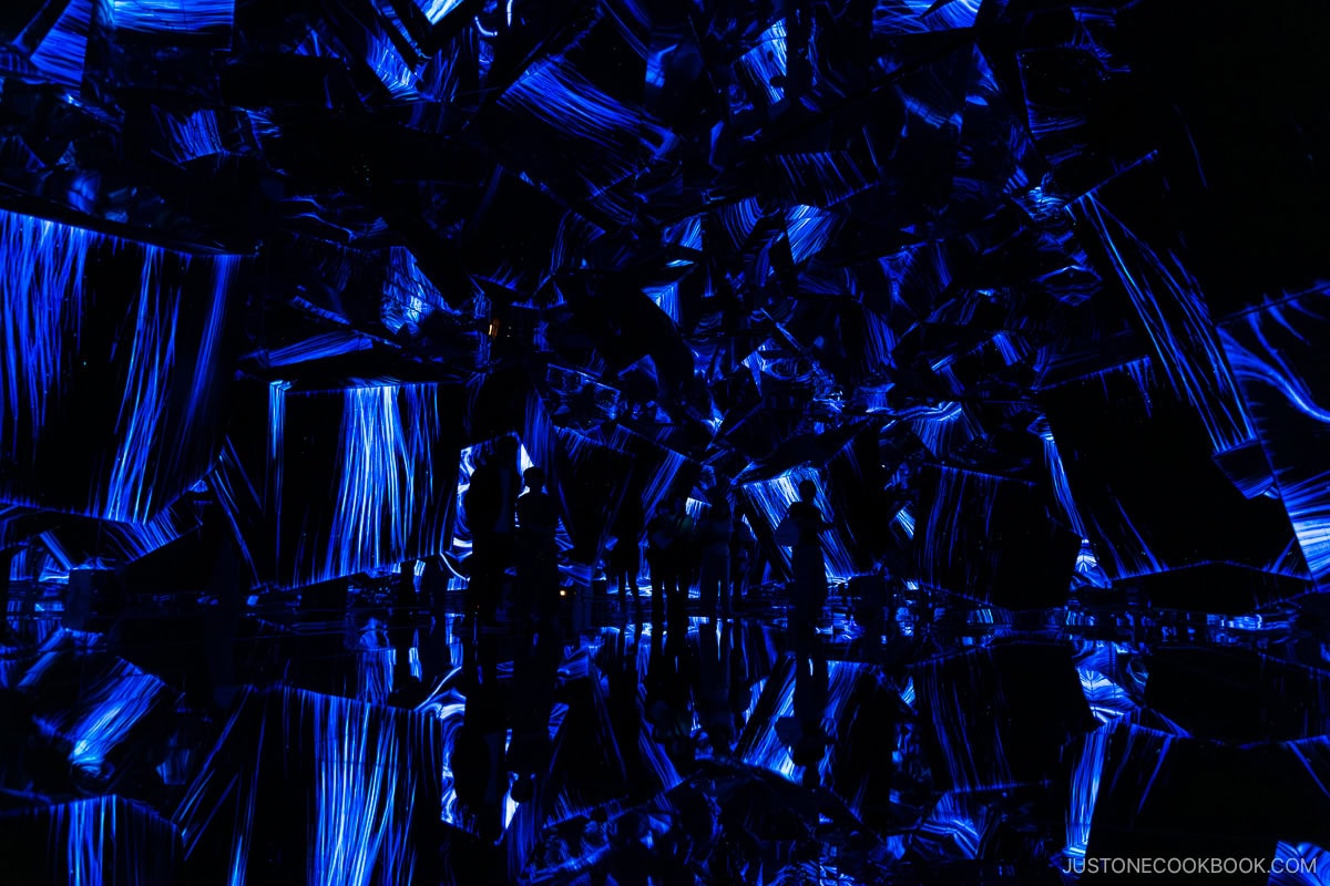 Room made of cubes with blue calligraphy projection mapping
