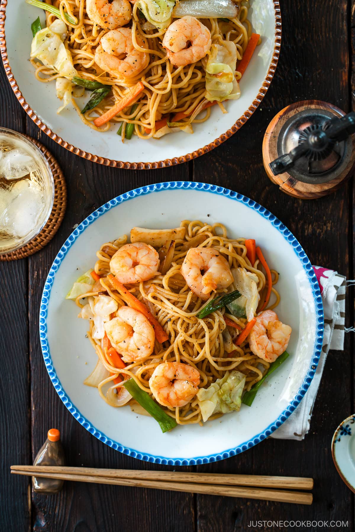 Round plates containing shrimp yakisoba.