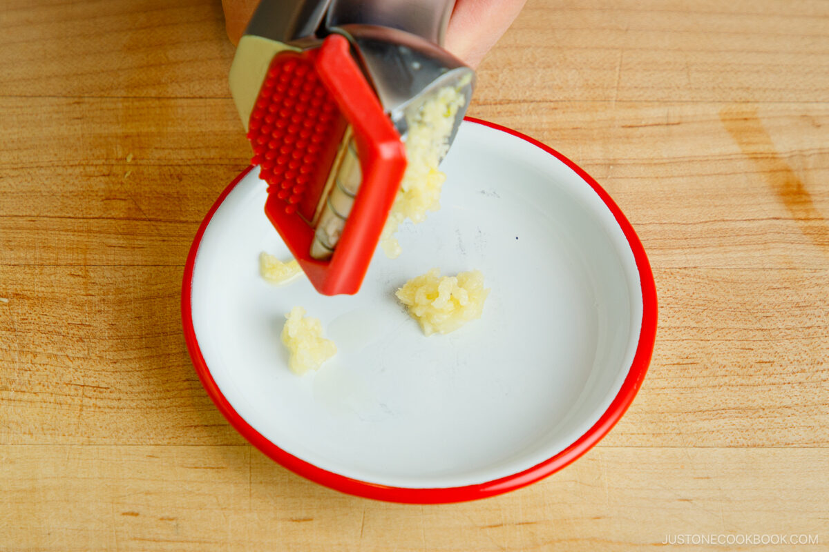 Crush the garlic cloves.
