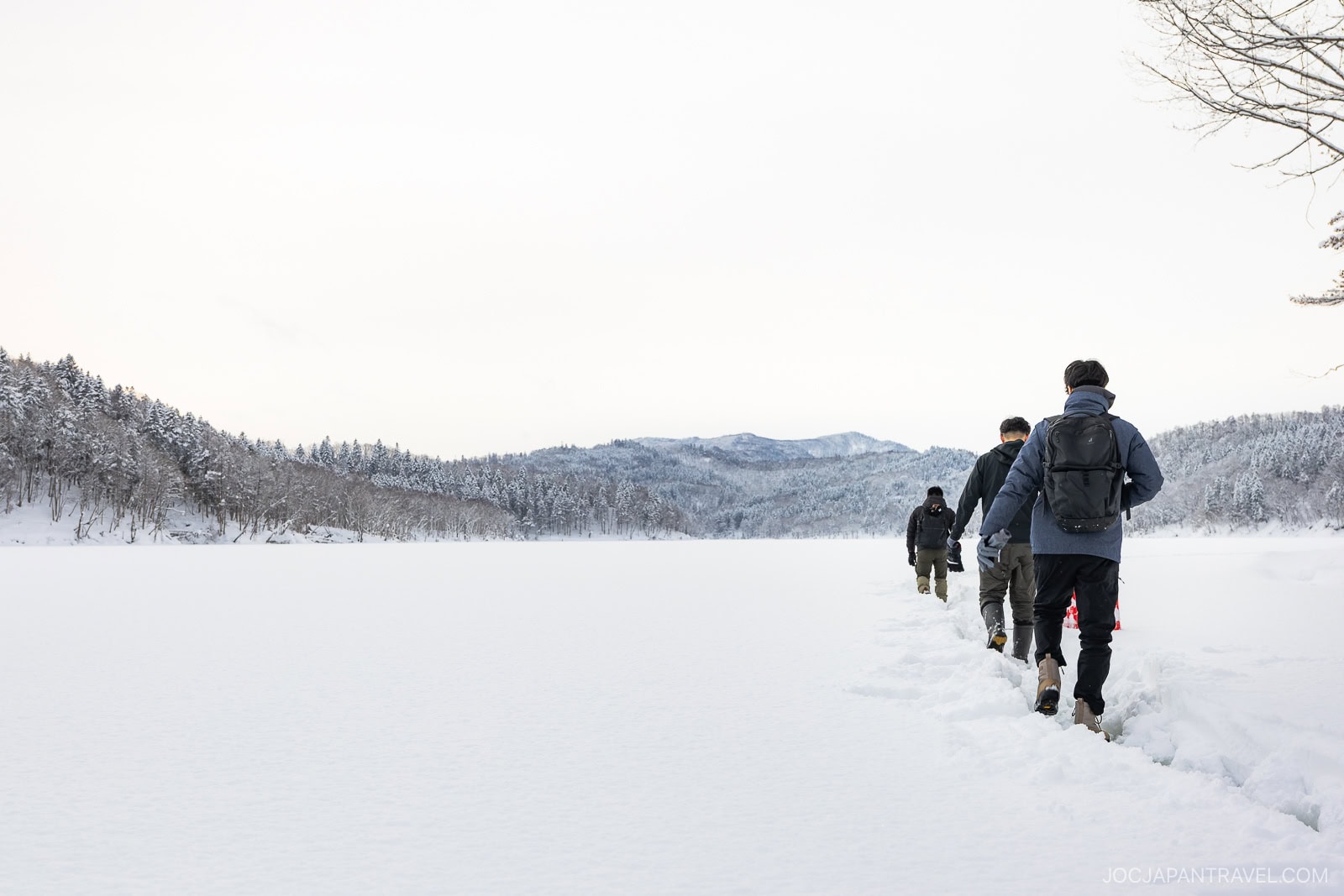 Walking over frozen lake with mountain in the background