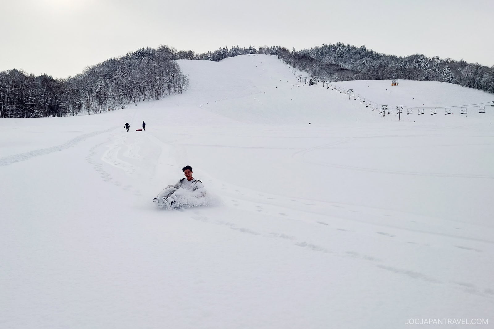 Sledging down snowy slope