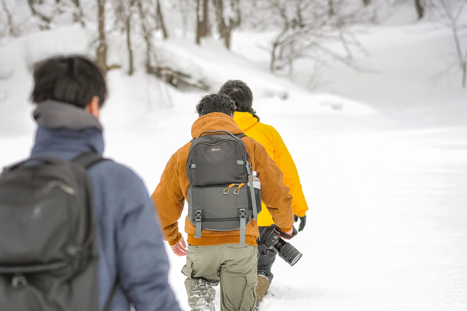 a group of people walking in snow