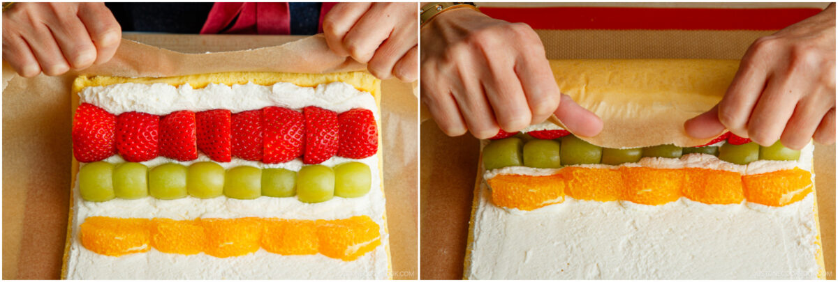 Two images showing hands rolling a sheet cake with whipped cream topped with rows of strawberries, green grapes, and orange slices using parchment paper.