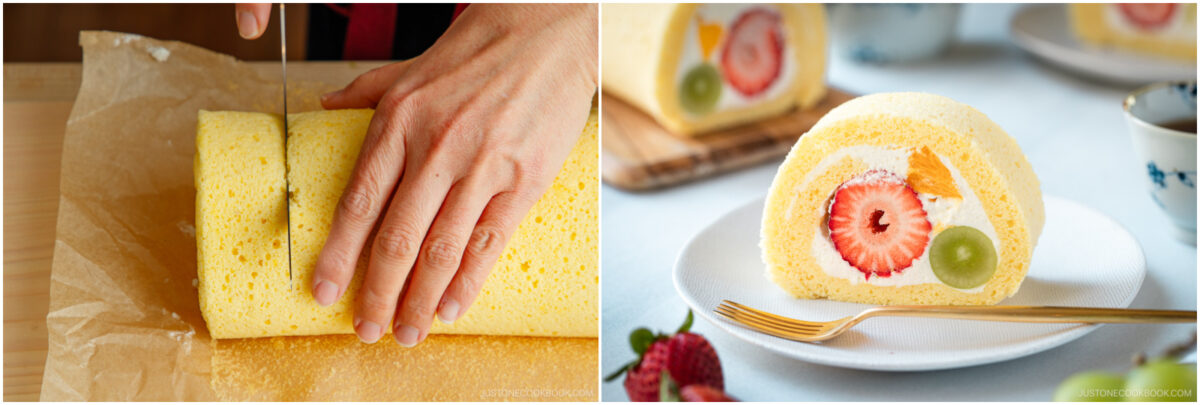 A hand slices a yellow sponge cake roll on parchment paper; next to it, a plated slice shows cream, a strawberry, an orange segment, and a grape inside the roll, with tea cups and more slices in the background.