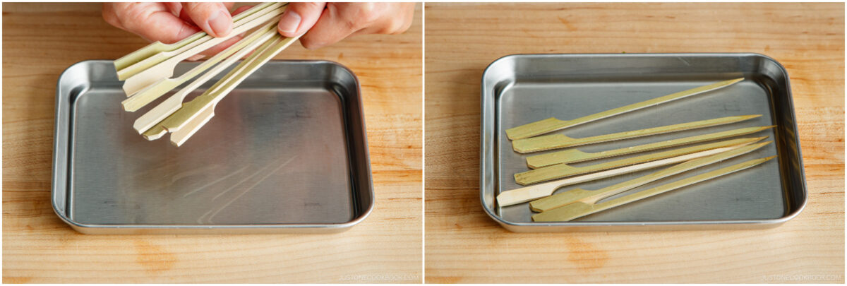 A hand places several bamboo skewers onto a metal tray on the left; on the right, the skewers are neatly arranged on the tray, all on a wooden surface.