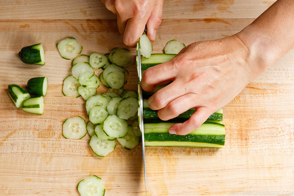 Thinly slice the cucumbers.
