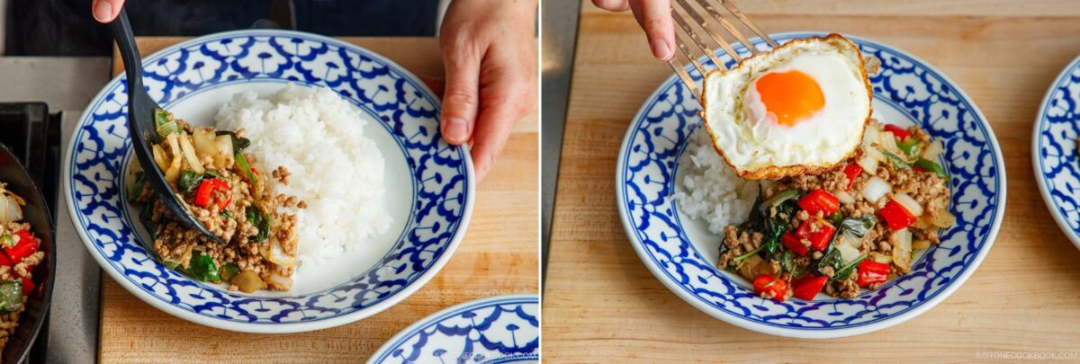 Two blue-and-white patterned bowls hold rice and stir-fried gapao rice with meat, vegetables, and basil; one bowl is being served, while the other has a fried egg on top and a fork beside it.