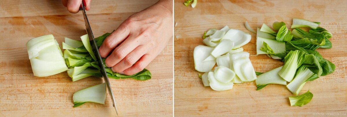 A person’s hand slices bok choy with a knife on a wooden cutting board; the chopped pieces are displayed beside the whole stalk, ready to be added to a flavorful bok choy and tofu stir-fry.