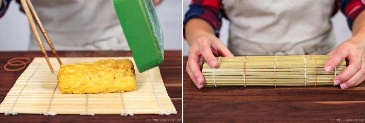 A person places a rectangular Dashimaki Tamago (Japanese Dashi Rolled Omelette) onto a bamboo sushi mat and rolls it up tightly with the mat, preparing authentic Japanese tamagoyaki.