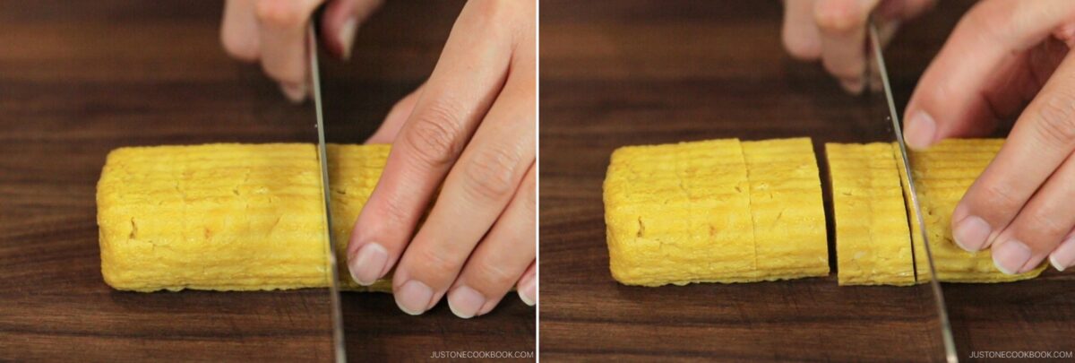 Close-up of hands slicing a yellow rectangular block of Dashimaki Tamago (Japanese Dashi Rolled Omelette) with a knife on a wooden cutting board.